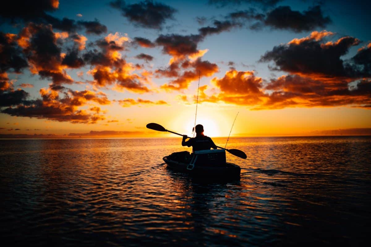 Man in fishing kayak at sea