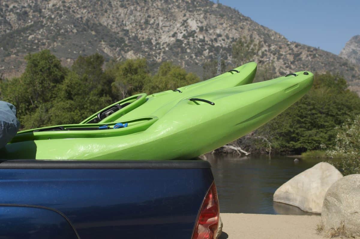 Two kayaks being hauled in pick-up truck