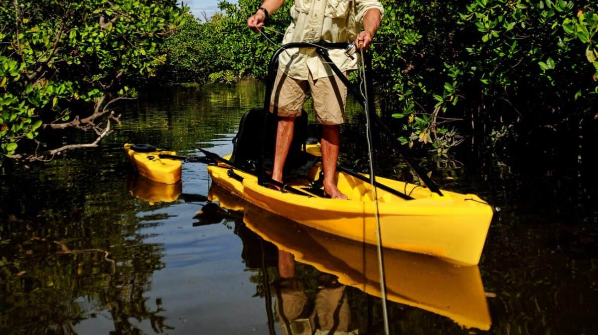 Yellow kayak with outriggers and stabilizers