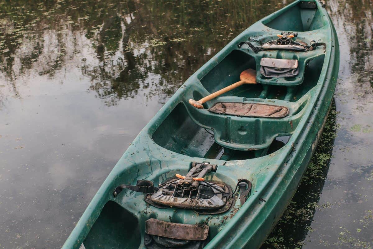 DIrty kayak in grey and dark water