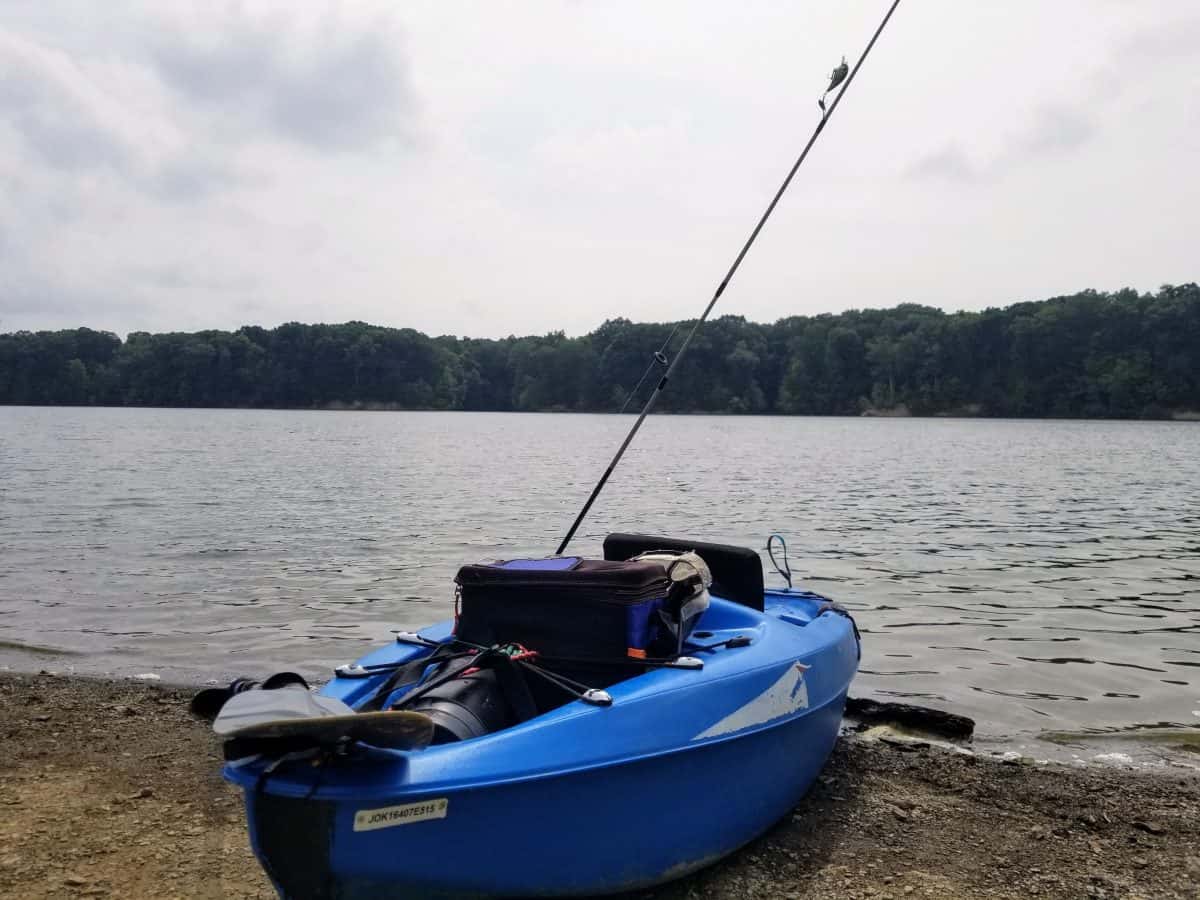 blue cheap kayaks for fishing on river bank