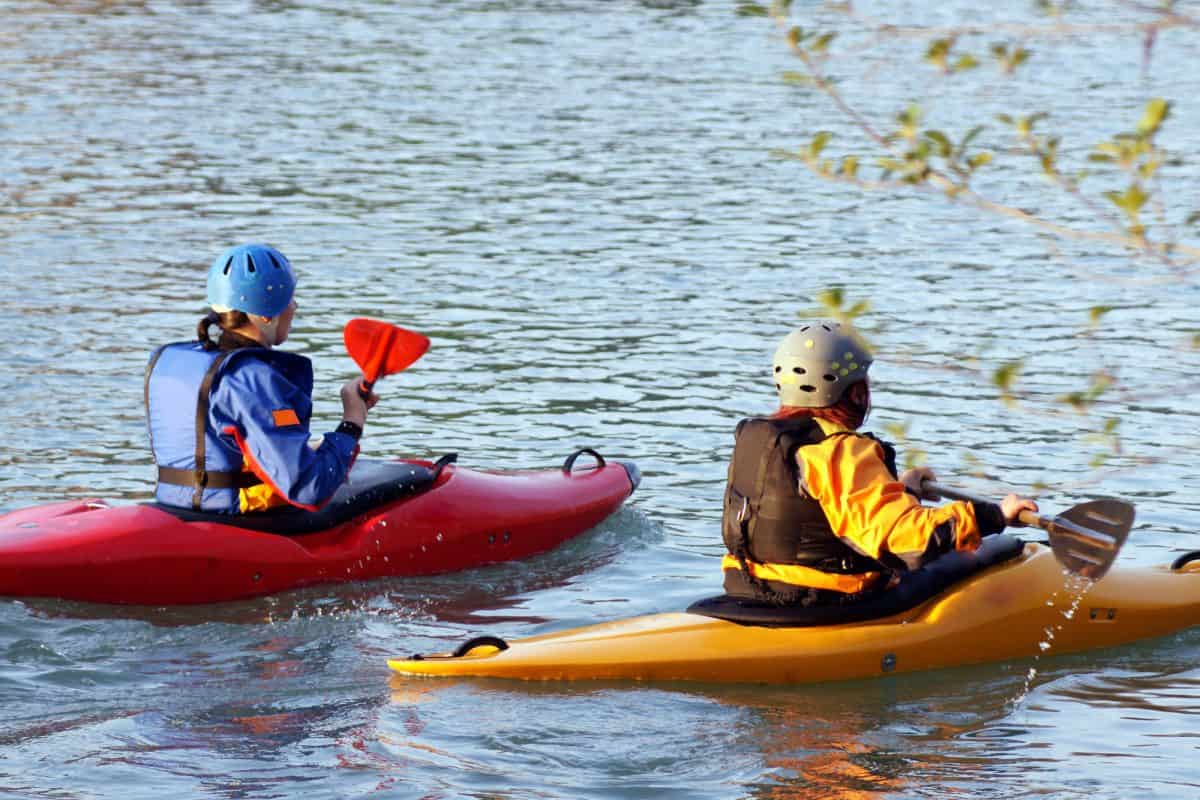 beginner whitewater kayakers taking a lesson