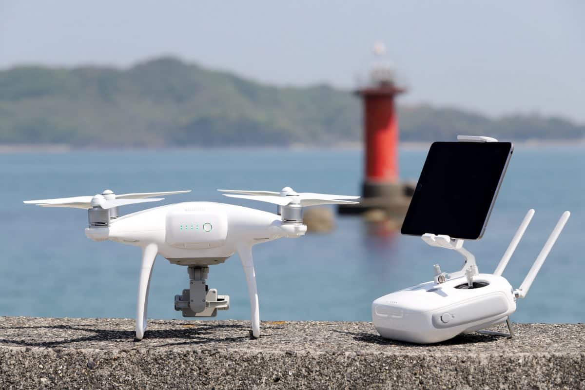 Fishing Drone and remote controller with monitor on concrete jetty