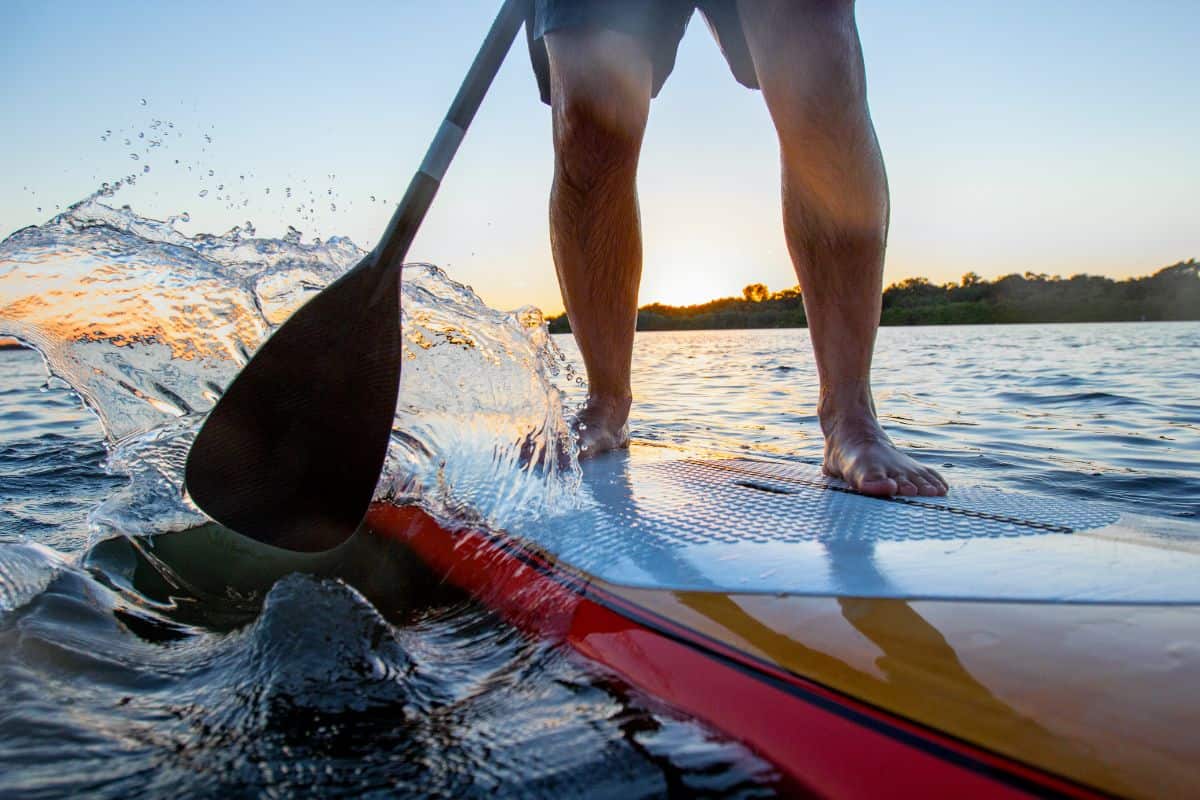 Man paddle boarding on wooden SUP