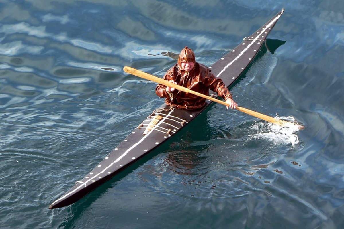 An Inuit kayaker clad in waterproof seal skin